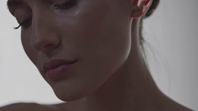 Soft movement across warm natural textures and gentle light, representing a calm and considered approach to supporting balanced skin.
